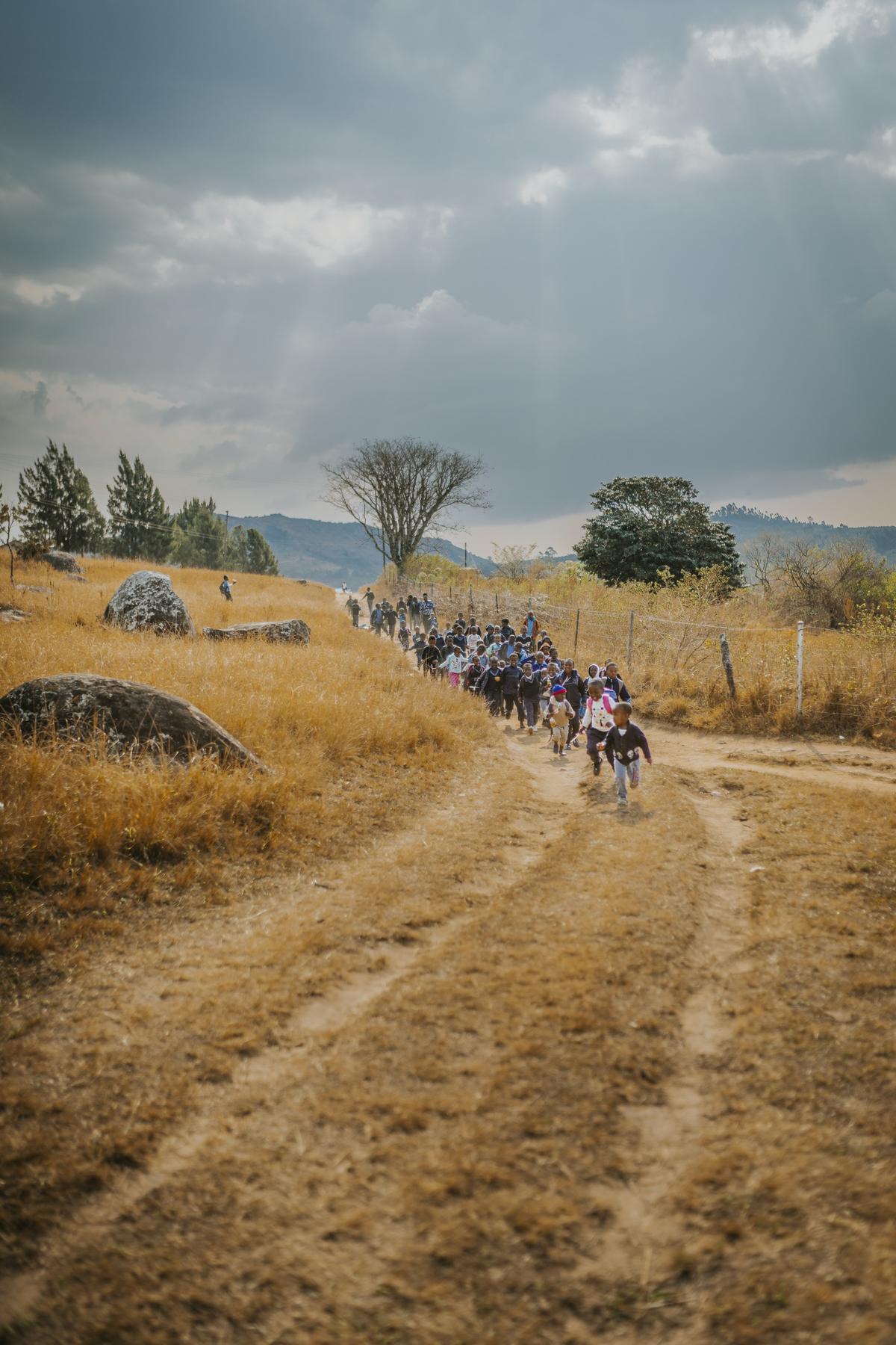 Schoolchildren walking a rural road in Eswatini